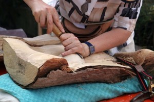 person carving wood